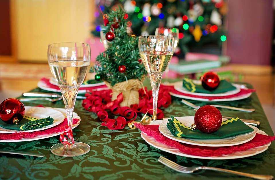 A Christmas table decorated with red glittery baubles. 
